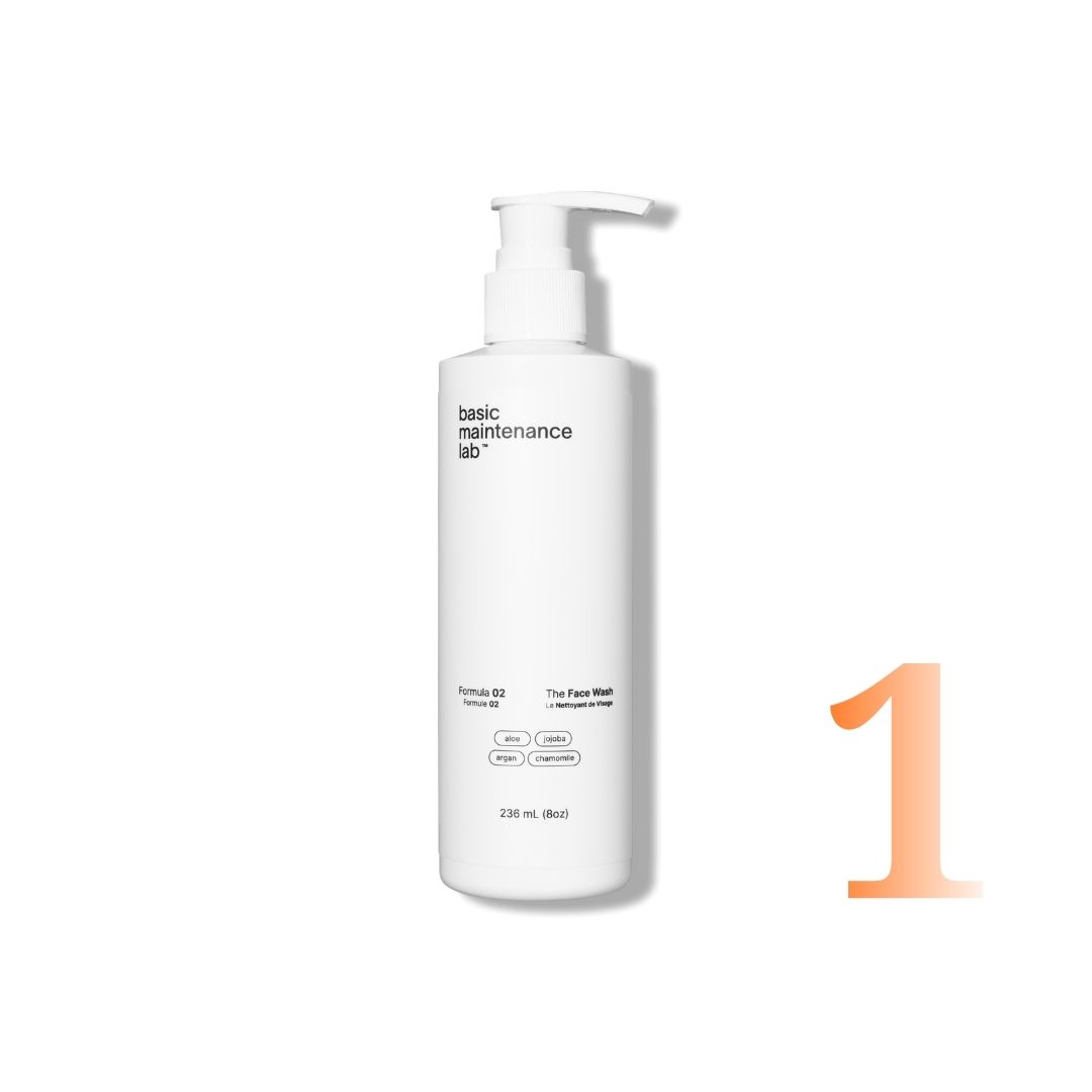 A white pump bottle of basic maintenance lab's The Face Wash next to a large orange number one.