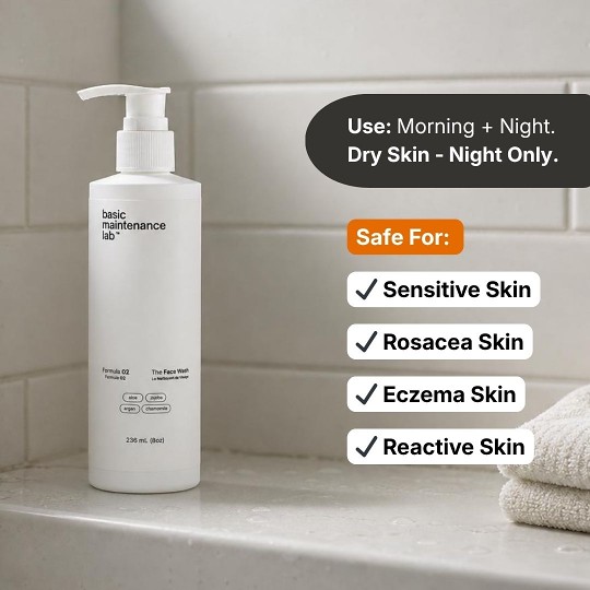 A white bottle of basic maintenance lab face wash on a bathroom counter with informational text overlays.