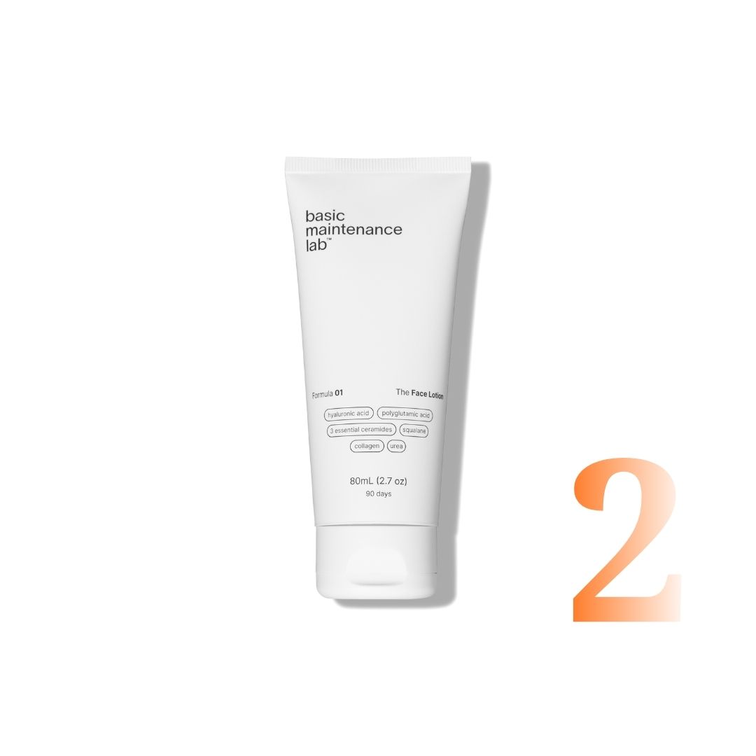 A white tube of Basic Maintenance Lab Face Lotion stands next to a large, orange number two.