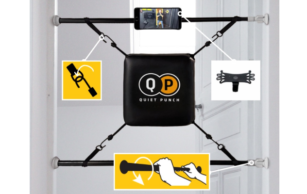 Doorway-mounted Quiet Punch boxing bag with phone holder attachments.