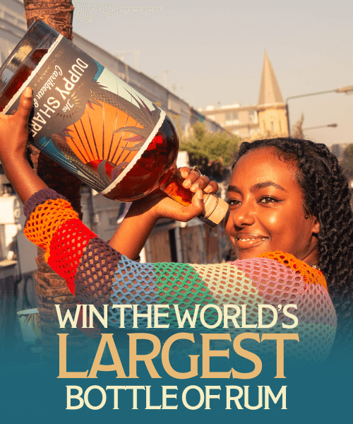 Person holding giant rum bottle, text reads 'Win the World's Largest Bottle of Rum'.