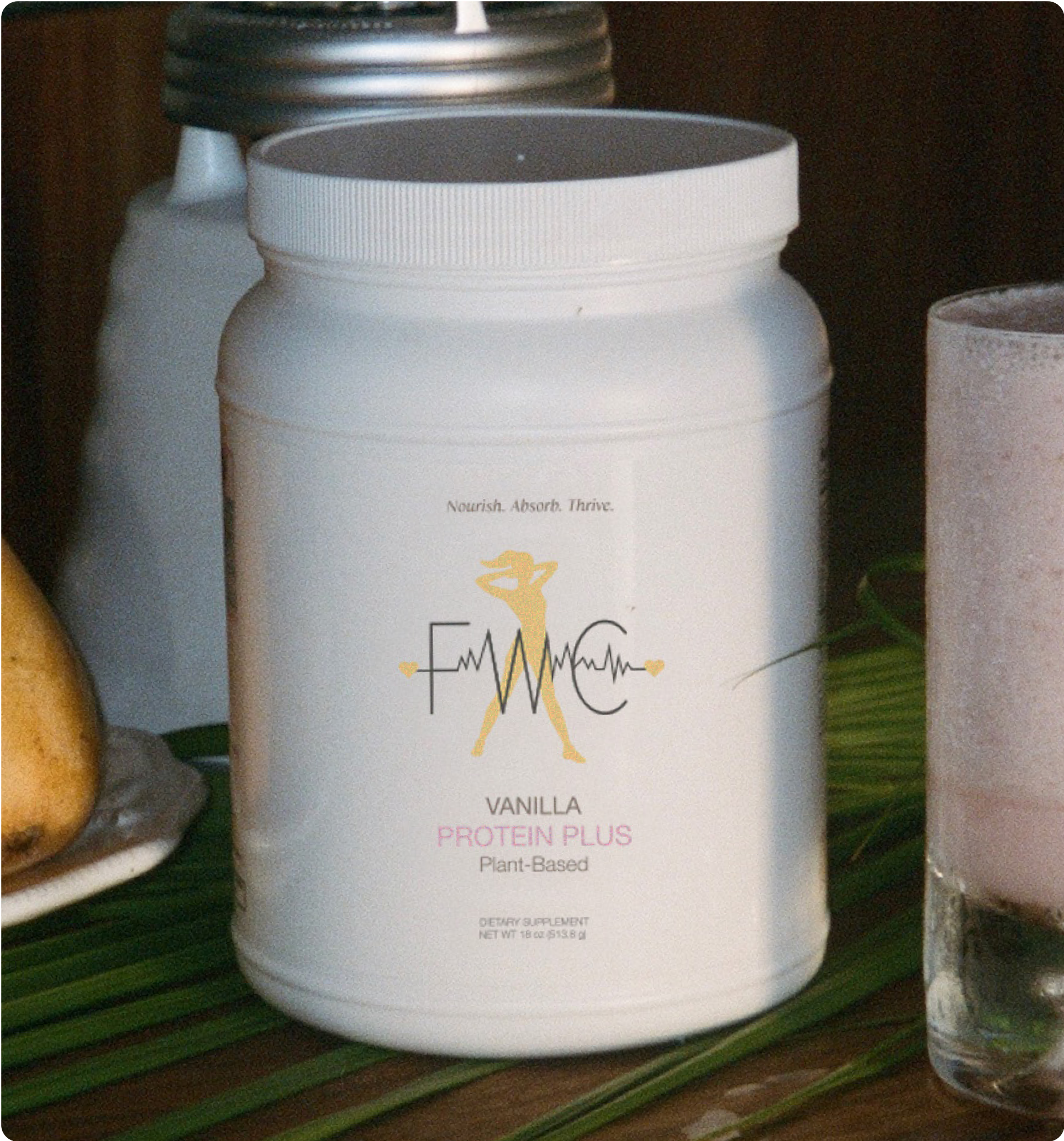 White container labeled 'Vanilla Protein Plus Plant-Based' next to a glass with pink liquid.