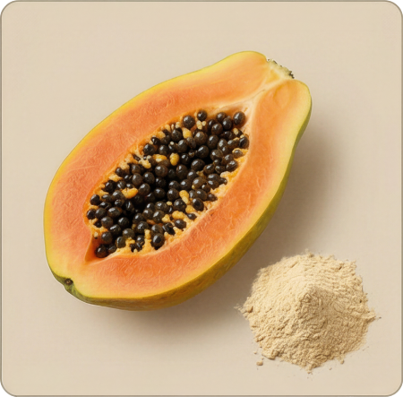 A halved papaya with its seeds exposed, next to a small pile of light brown powder.