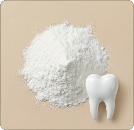 An overhead view of a pile of white powder next to a model of a tooth.