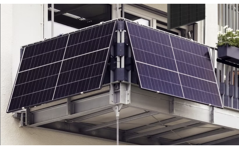 Solar panels mounted on a balcony railing of a building.