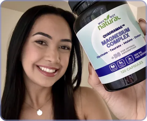 A smiling woman holds up a bottle of Why Not Natural Quadramag Magnesium Complex supplements.