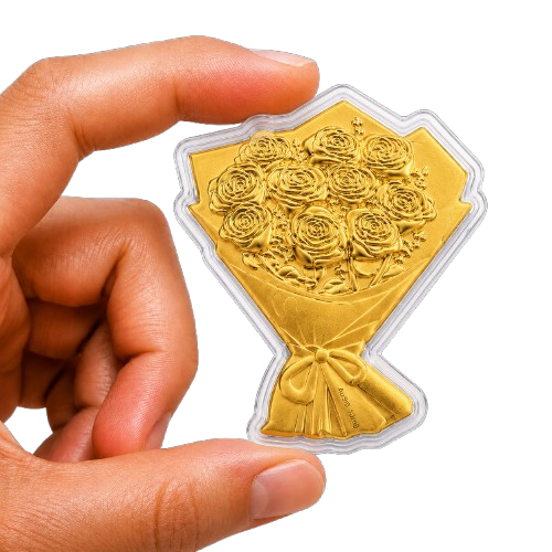 A hand holds a small, gold-plated plaque shaped like a bouquet of roses against a white background.