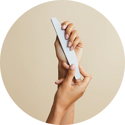 Hands holding a nail file against a beige background.