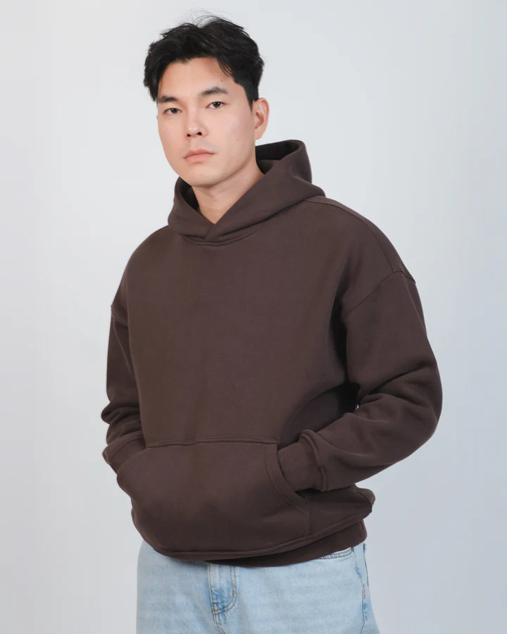 Person wearing a light blue denim jacket and jeans against a white background.