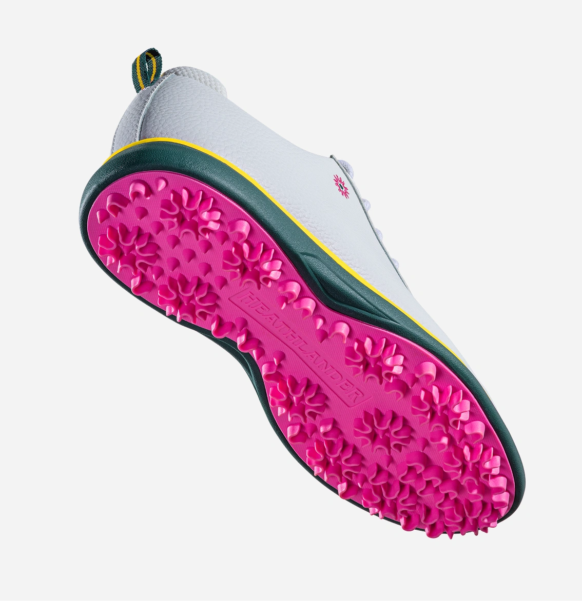 A white shoe with a bright pink textured sole, viewed from underneath against a plain background.