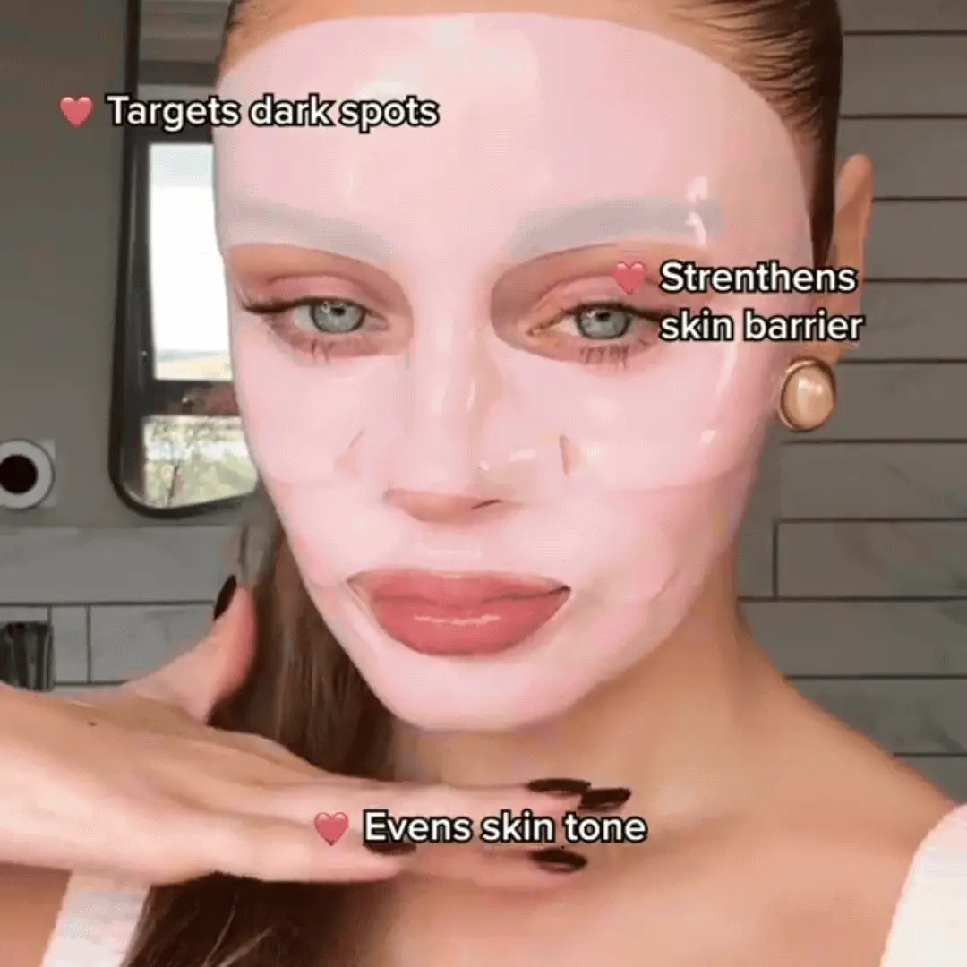 Person wearing a pink face mask with text about skincare benefits.