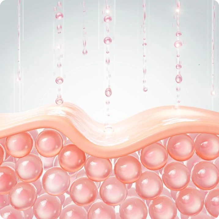 A graphic illustration of pink liquid droplets absorbing into a cross-section of skin layers with spheres underneath.