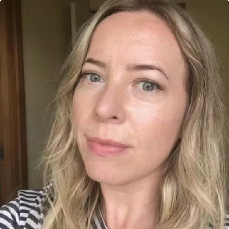 Close-up of a person with blonde hair and striped shirt.