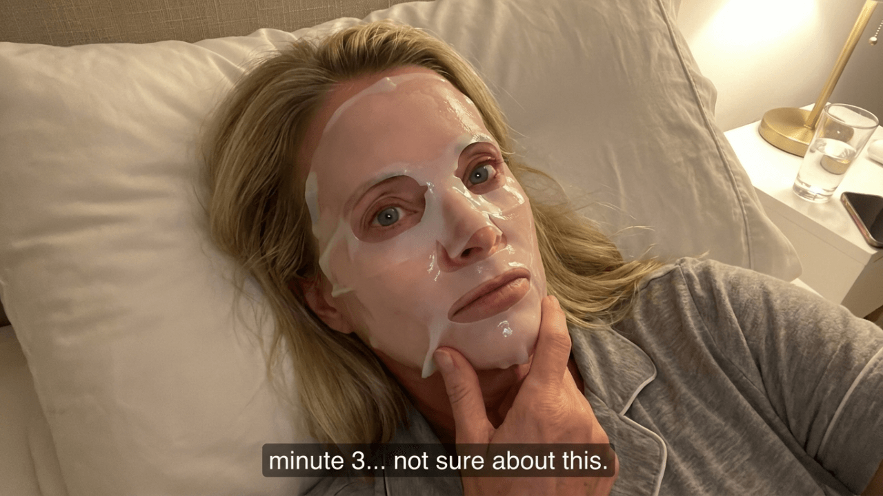 Person lying down wearing a face mask and looking unsure.