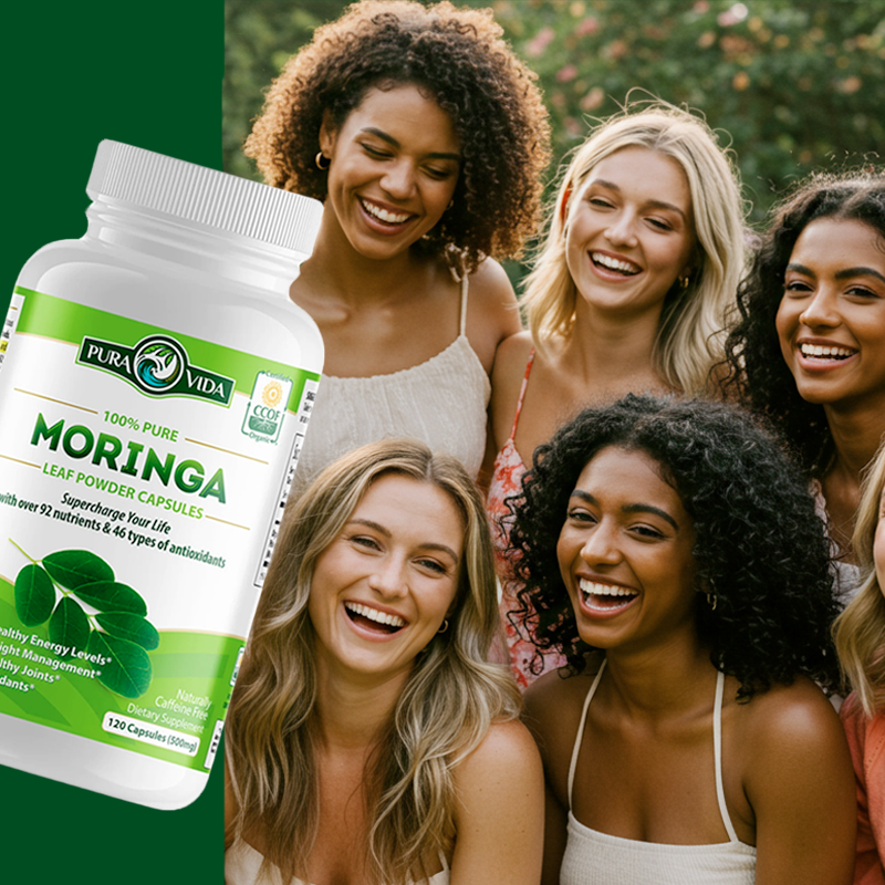 Group of smiling women with a bottle of Moringa leaf powder capsules.