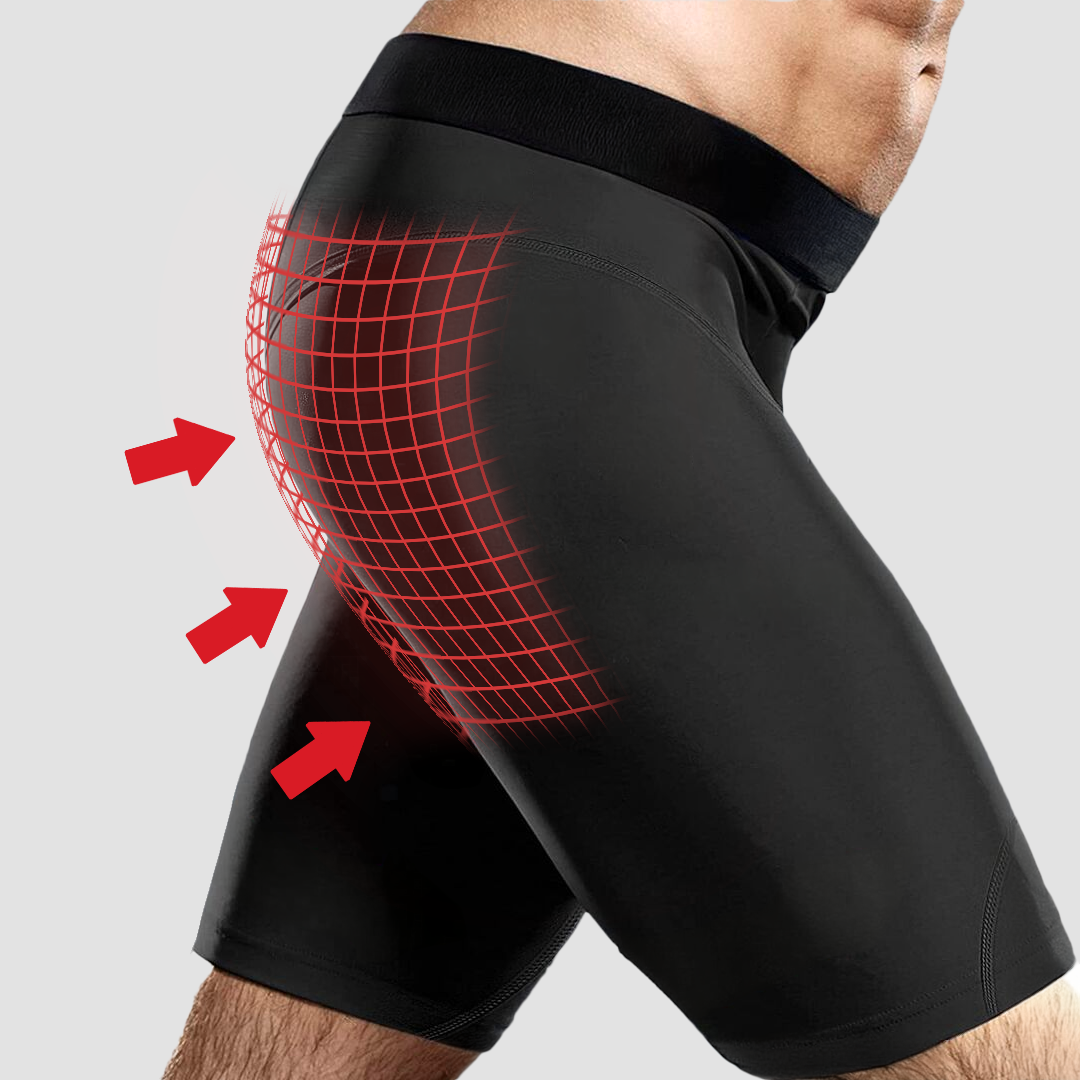 Man wearing black compression shorts with red grid and arrows highlighting the hip area.