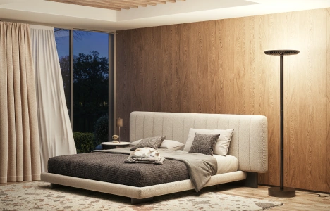 A modern bedroom with a wood-paneled accent wall, an upholstered bed, and a minimalist floor lamp.