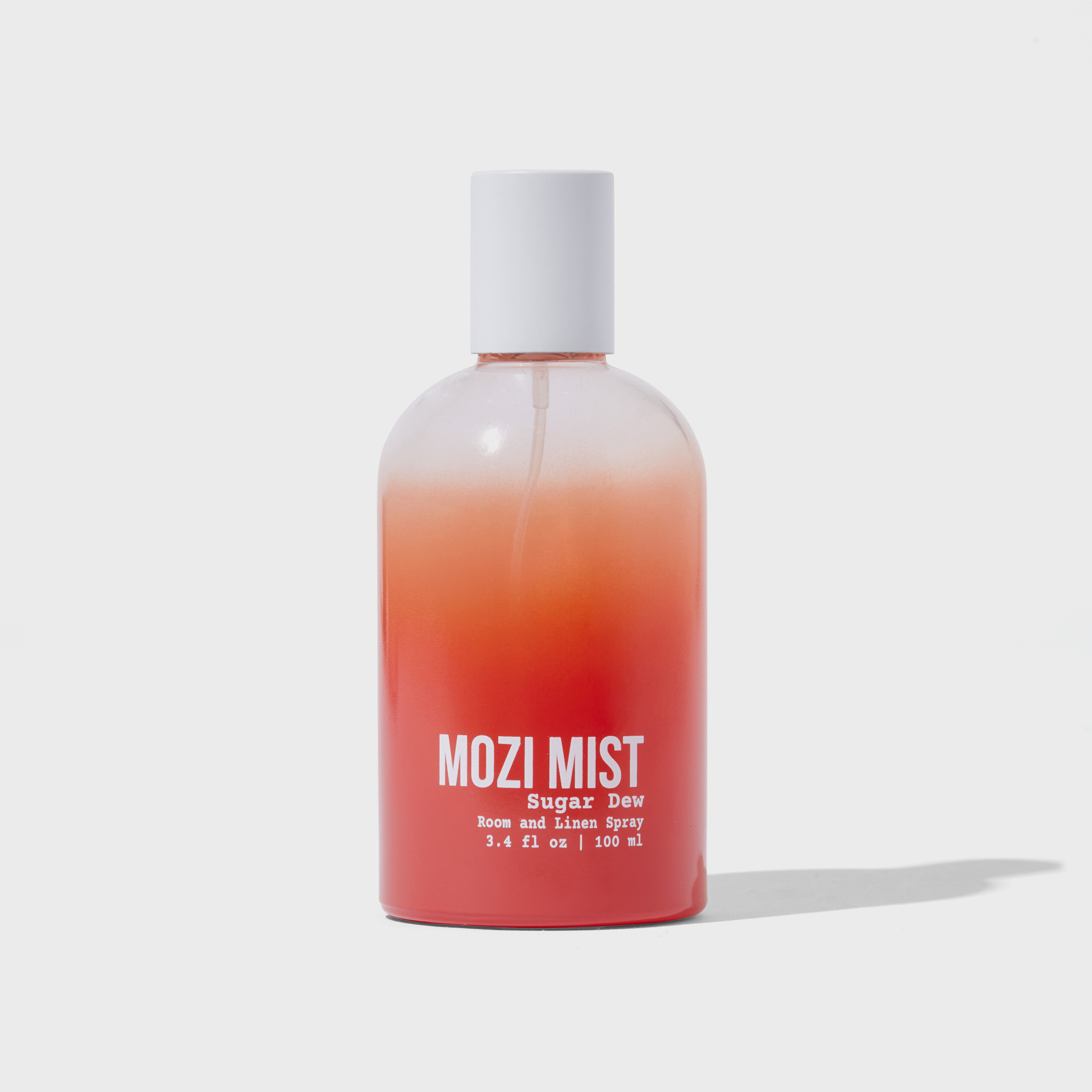 Red and white gradient bottle labeled 'MOZI MIST Sugar Dew' room and linen spray.