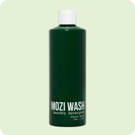 A dark green bottle of Mozi Wash laundry detergent against a light green background.
