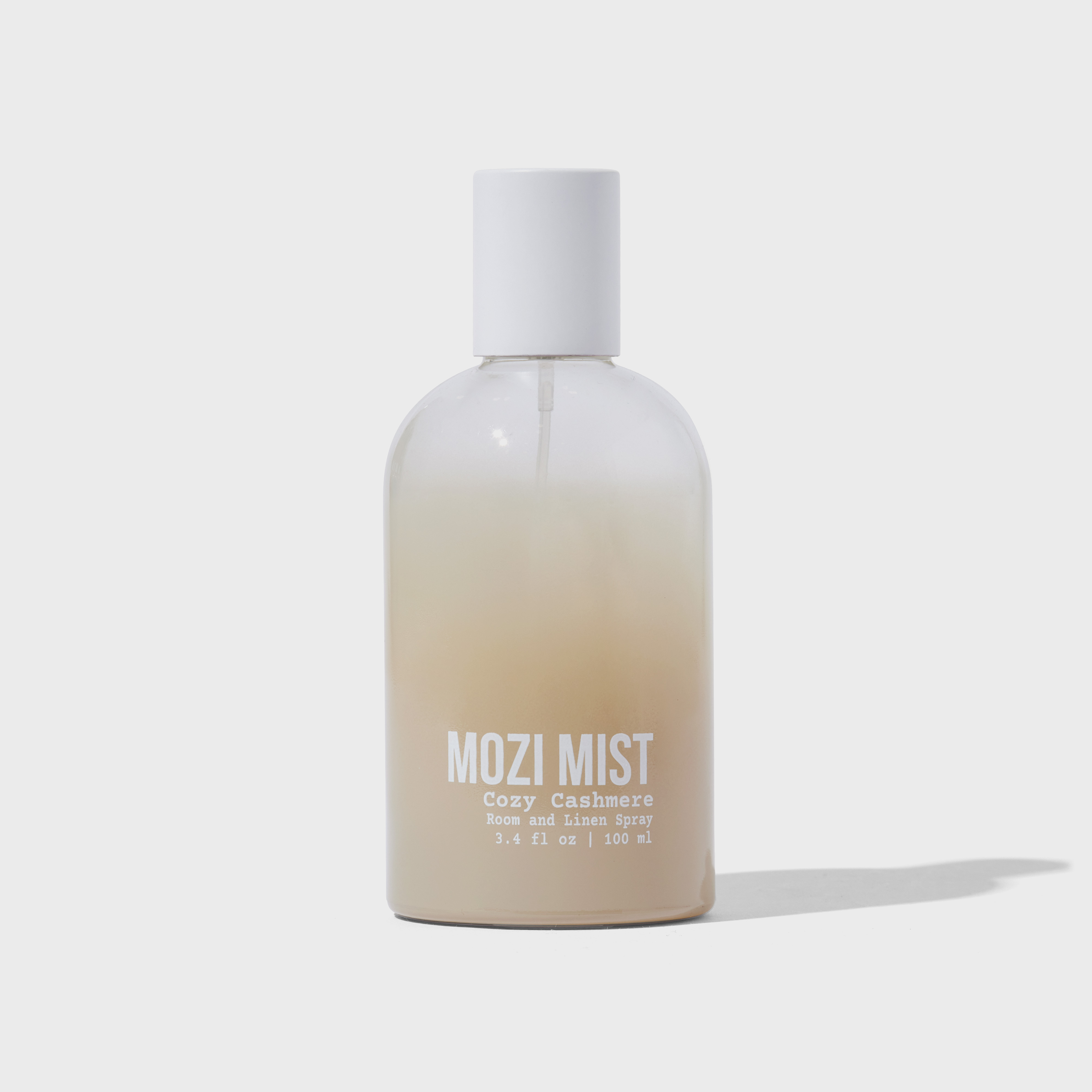 Clear bottle of Mozi Mist room spray with white cap.
