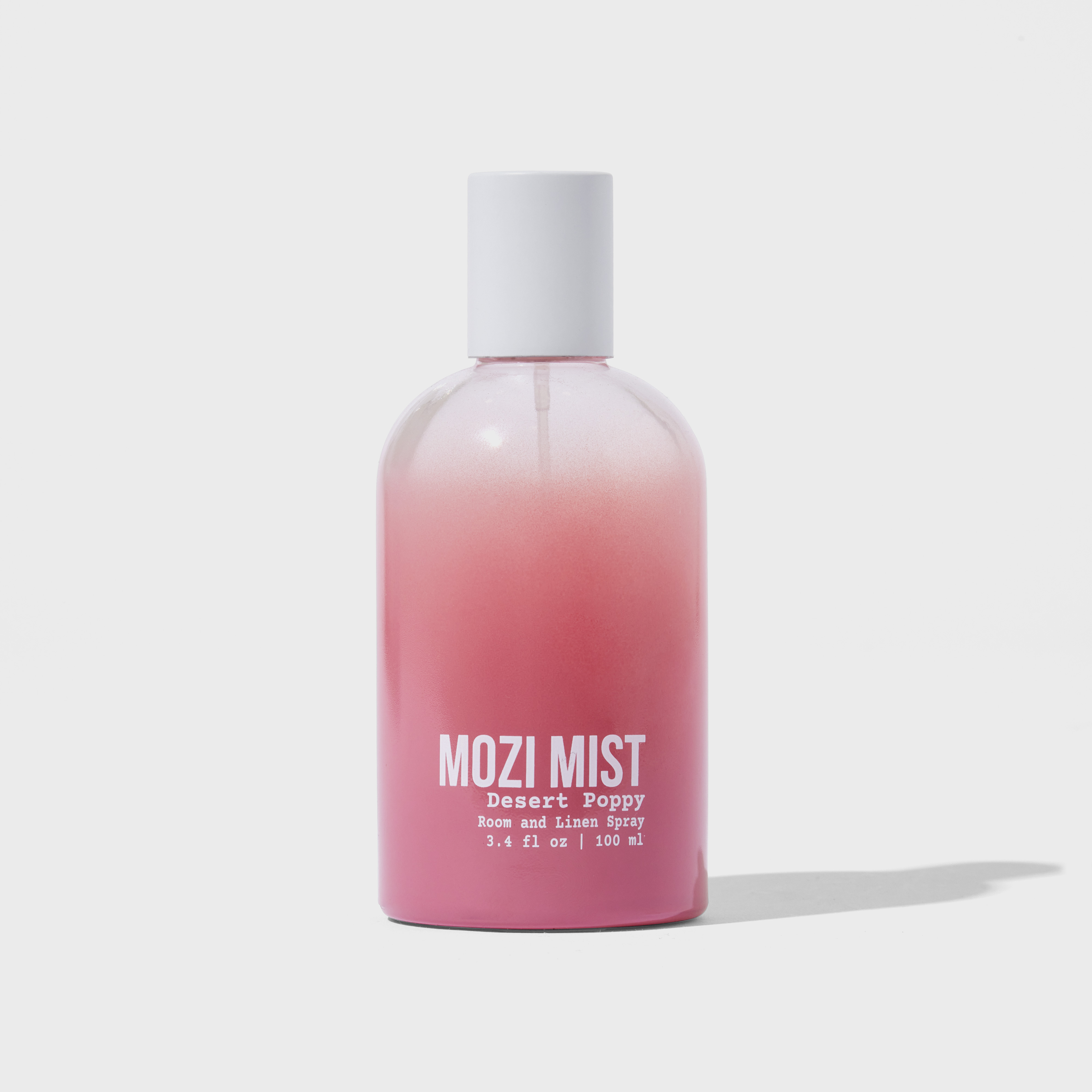 Pink bottle labeled 'Mozi Mist Desert Poppy Room and Linen Spray' against a white background.