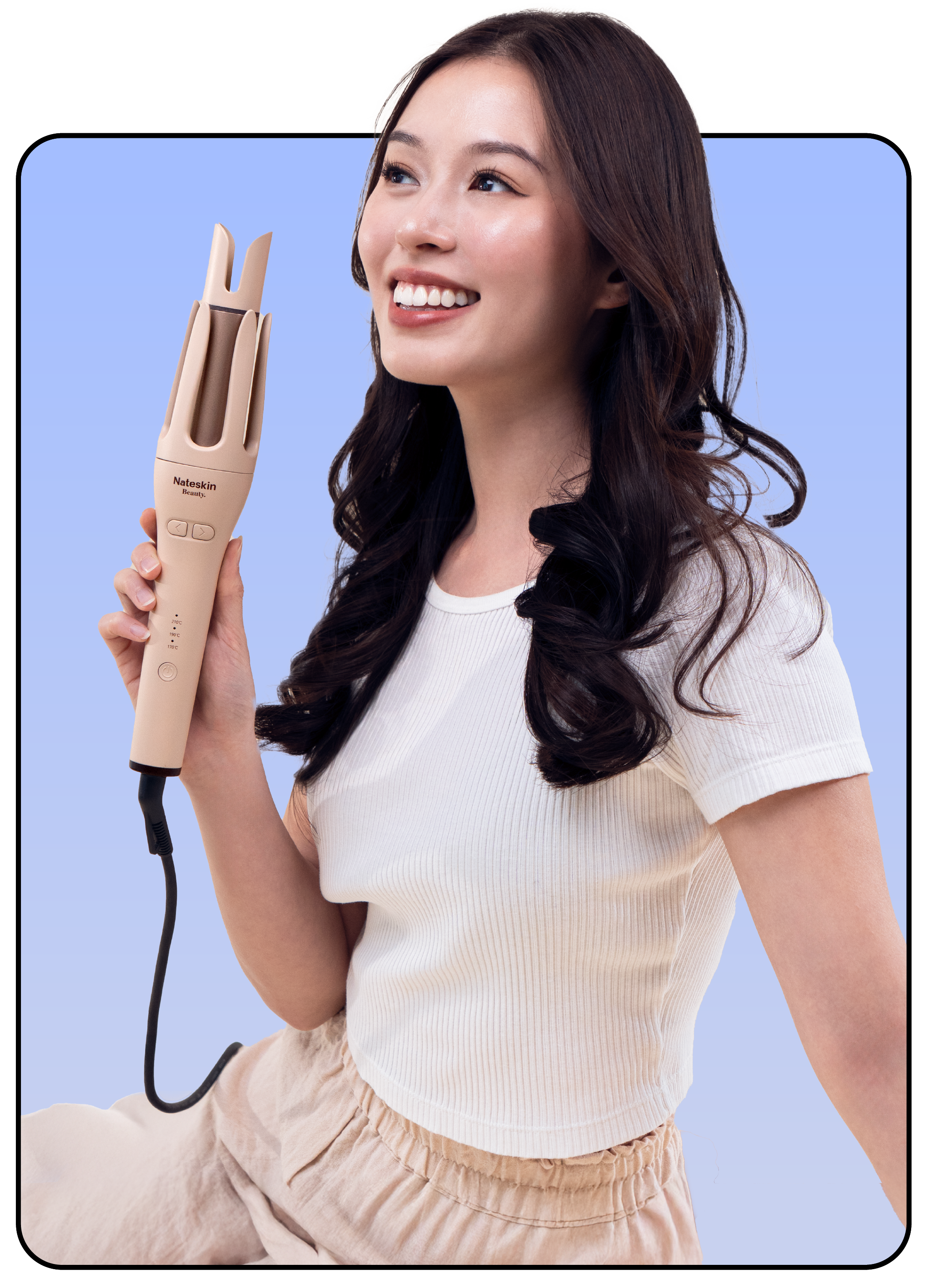 Smiling person holding a hair styling tool against a blue background.