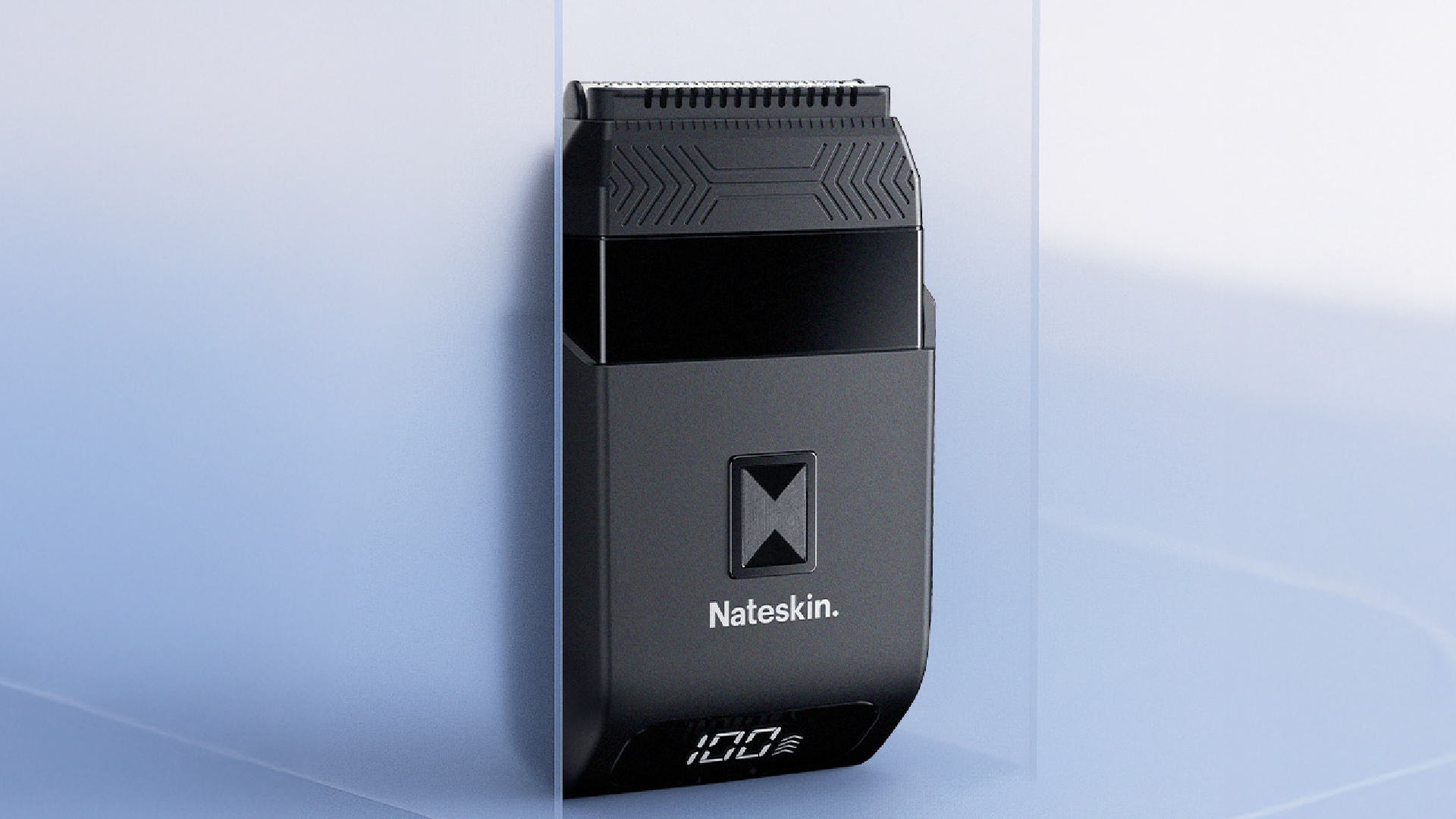 Black electric shaver with digital display, on a light blue background.