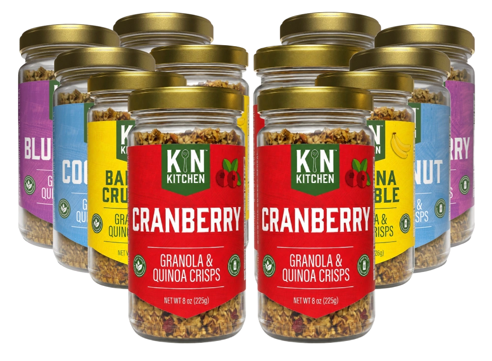 Multiple jars of KIN KITCHEN Granola & Quinoa Crisps in various flavors, arranged on a white background.