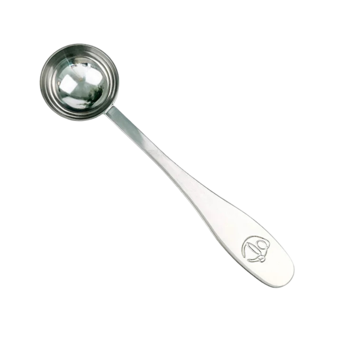Stainless steel measuring spoon with engraved handle.