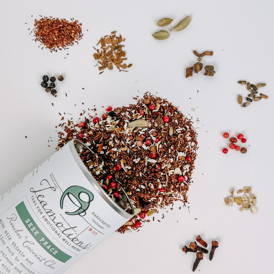 Spices and herbs spilling from a labeled container on a white surface.