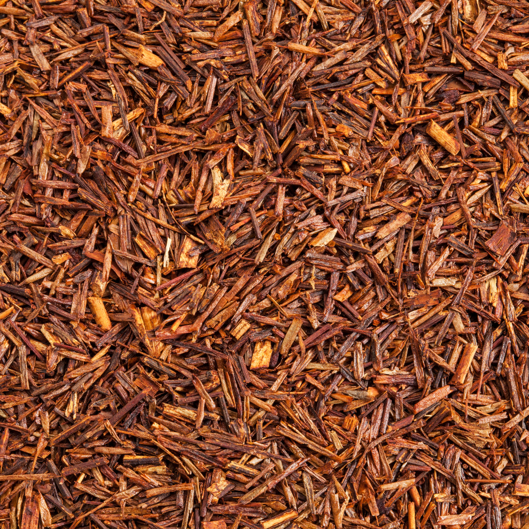 Close-up of brown tea leaves scattered uniformly.