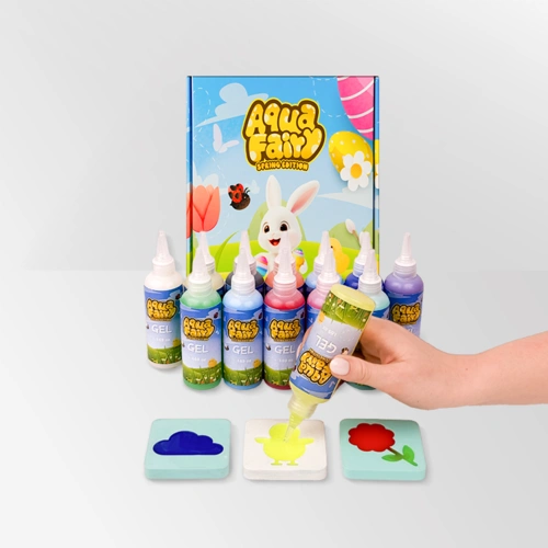 A hand uses colorful gel paints from a bunny-themed craft kit.