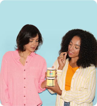 Two women holding a container against a light blue background.