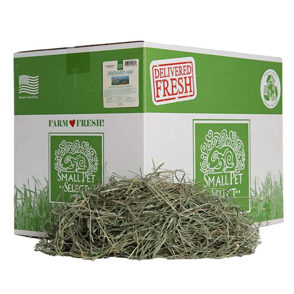 Box labeled 'Small Pet Select' with hay piled in front of it.