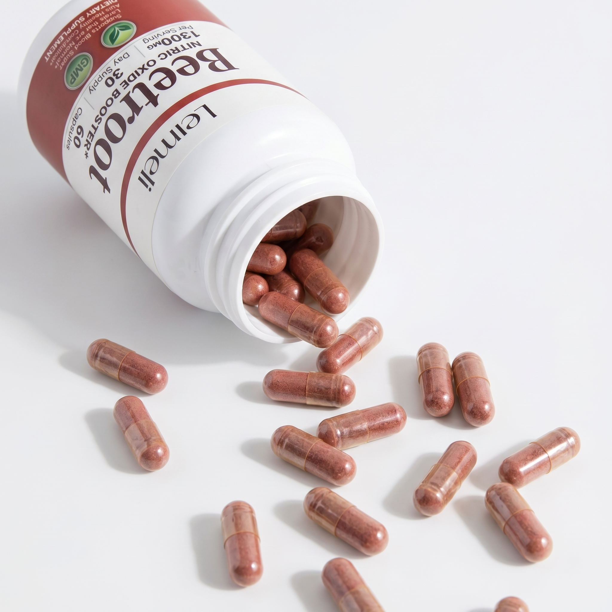 A white bottle of Leimell Beetroot supplement capsules spilling onto a white surface.