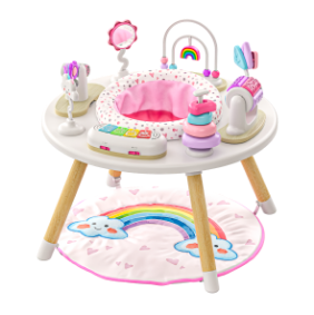 A white and pink baby activity center with attached toys and a rainbow playmat on the floor.