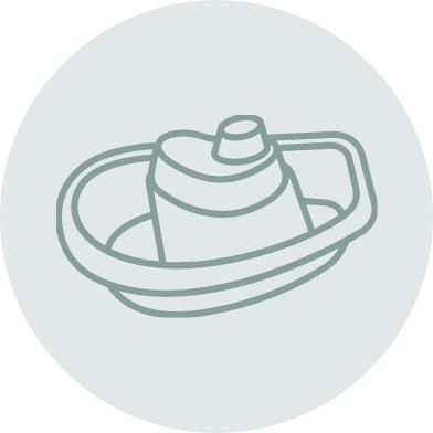 An illustration of a sippy cup with handles sitting in a shallow bowl.