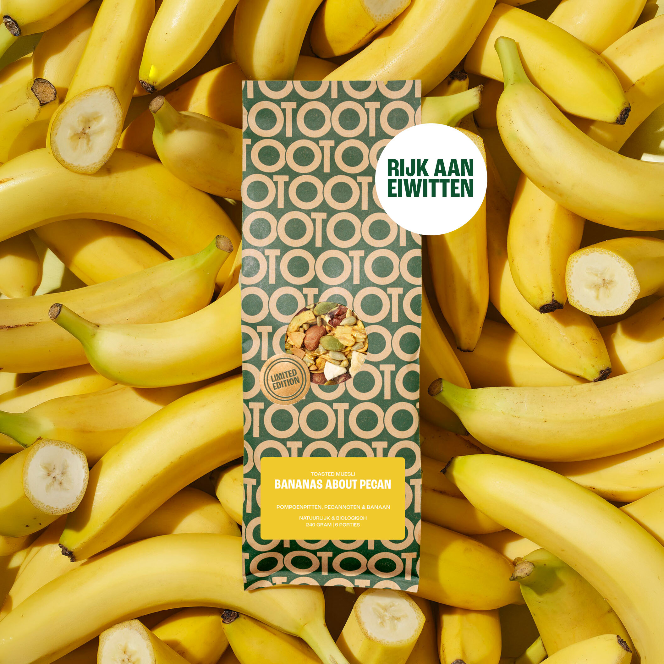 A bag of Bananas About Pecan toasted muesli is laying on a pile of fresh bananas.