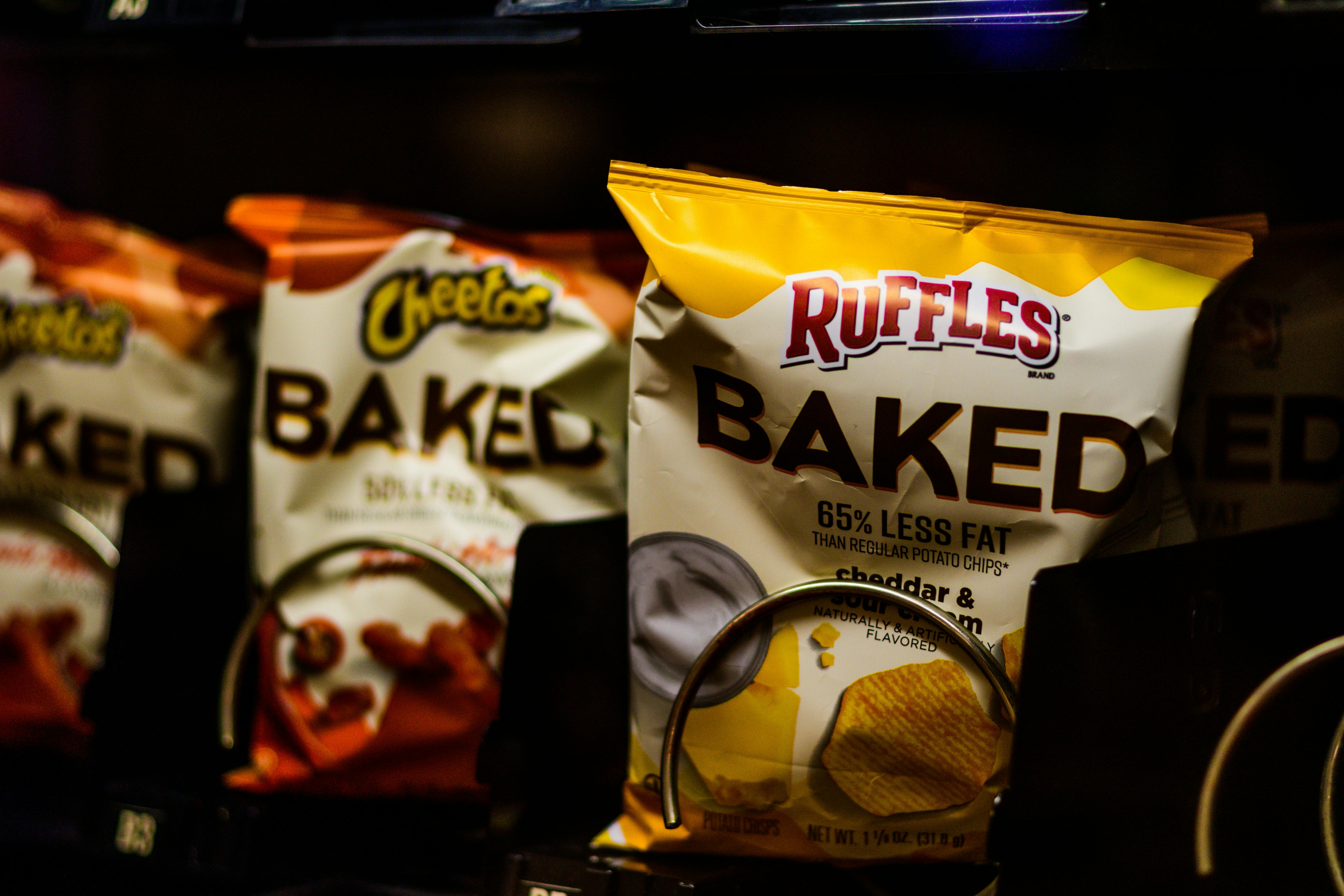 Bags of baked chips in a vending machine.