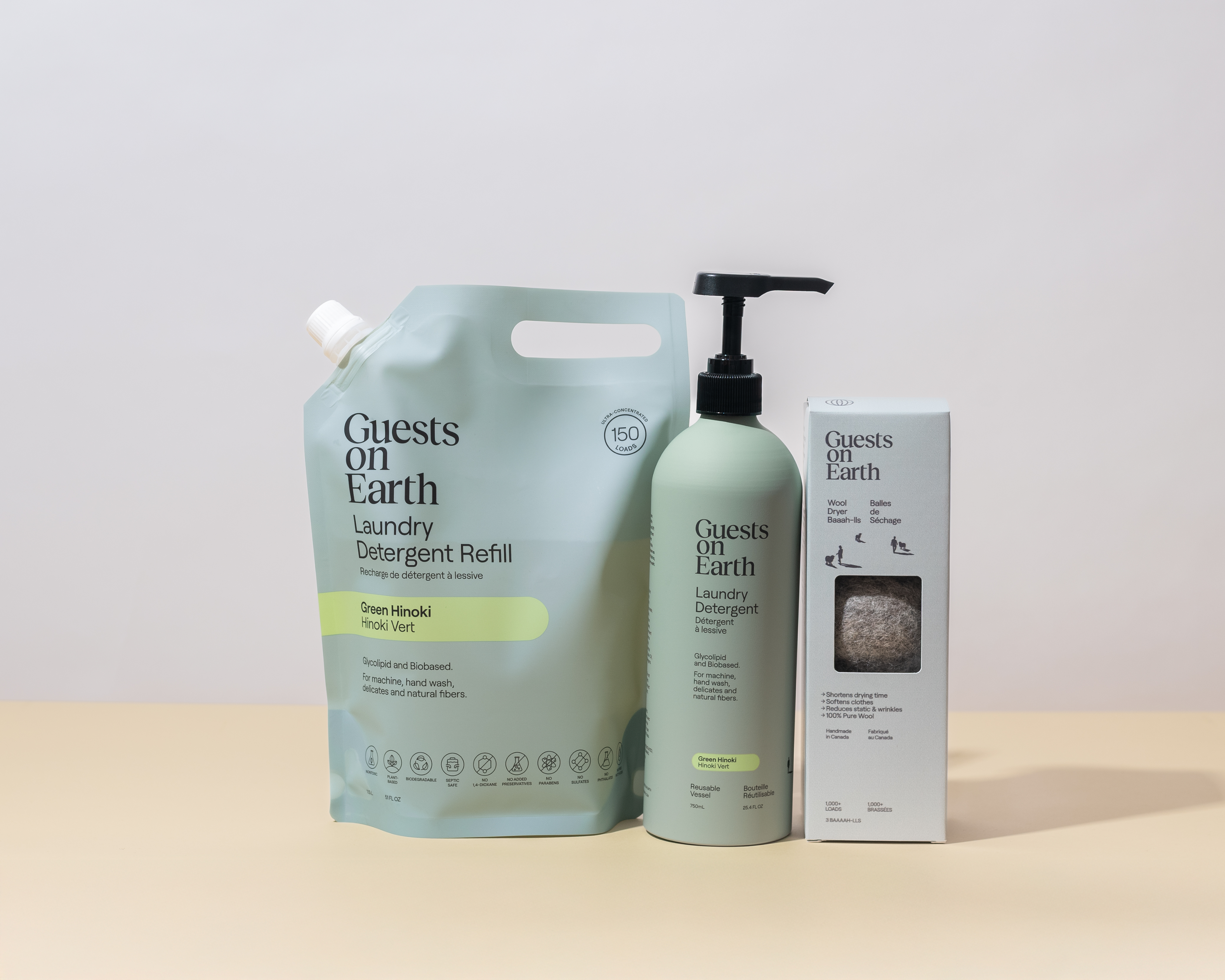 Three eco-friendly laundry products on a beige surface.