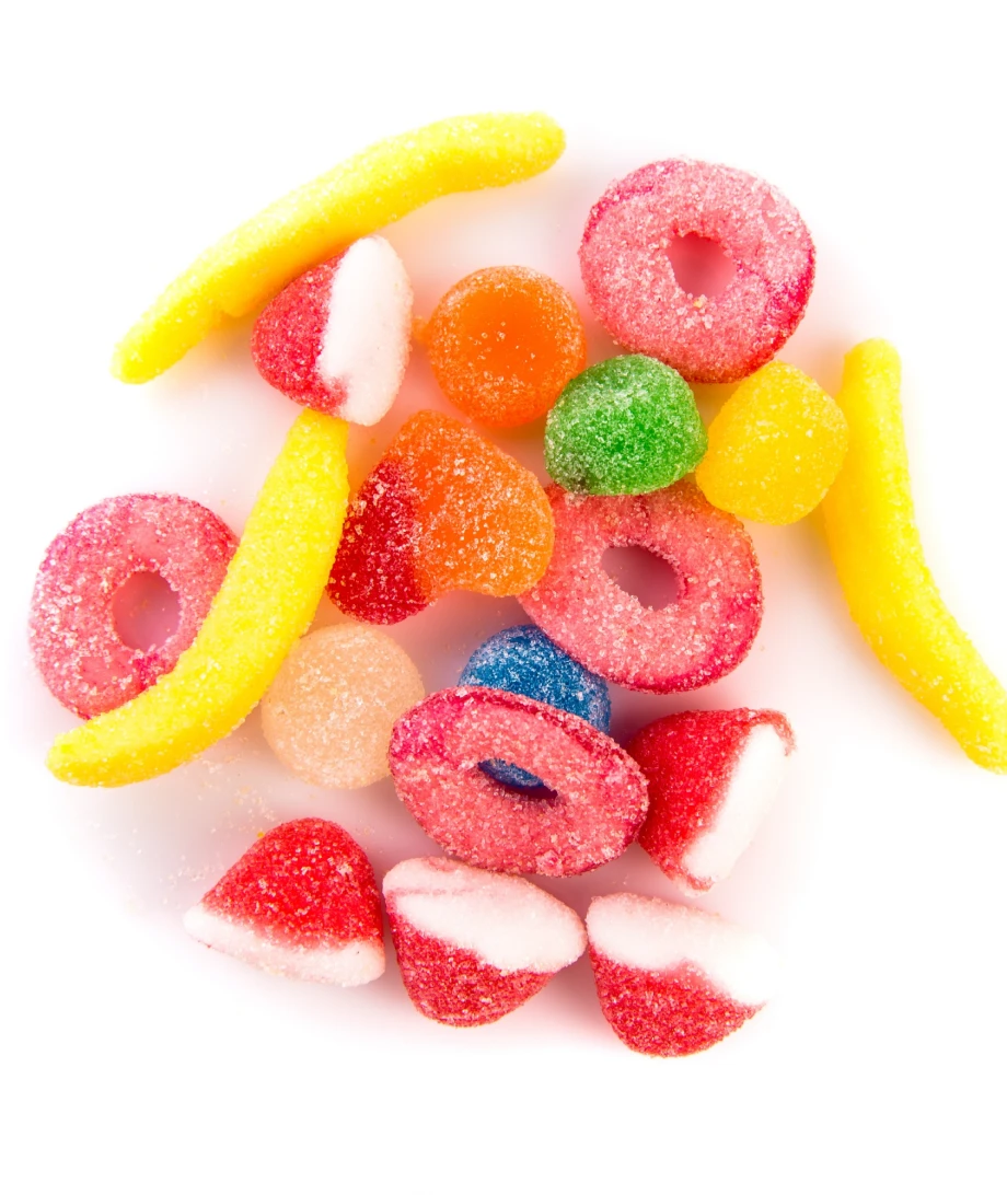 Assorted colorful gummy candies on a white background.