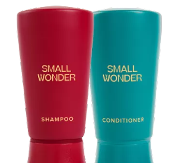 Red shampoo and teal conditioner bottles labeled 'Small Wonder.'