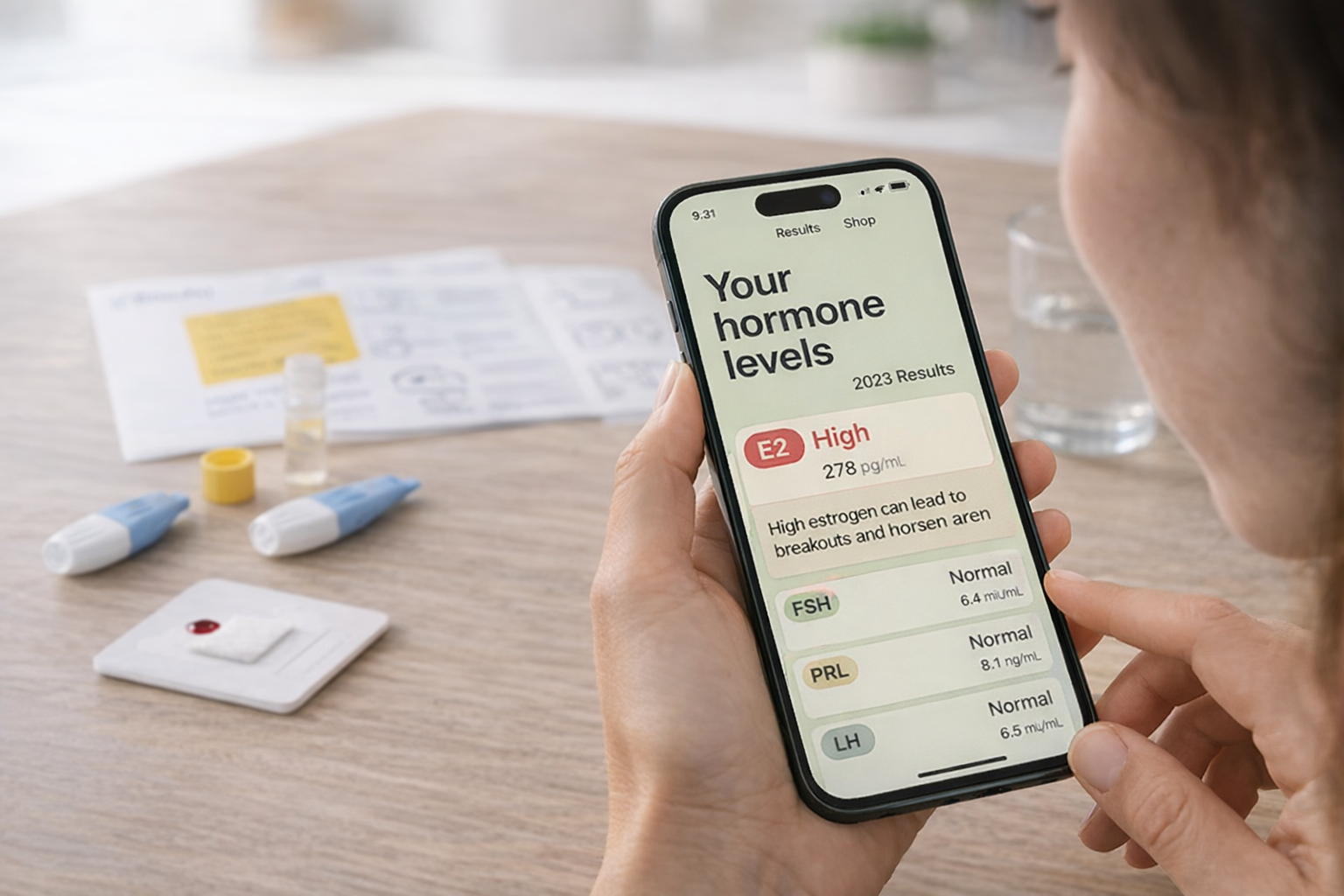 A person views their hormone level results on a smartphone, with an at-home test kit on the table.