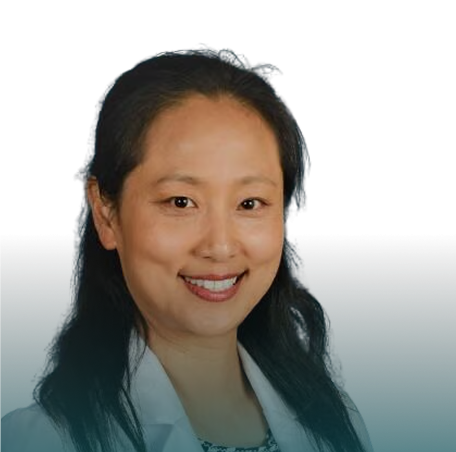 Headshot of a smiling woman with dark hair, wearing a white coat against a gradient background.