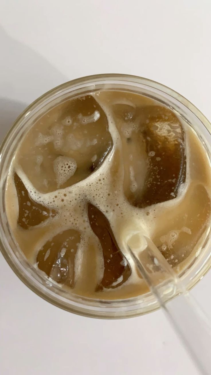Iced coffee in a glass with a straw.