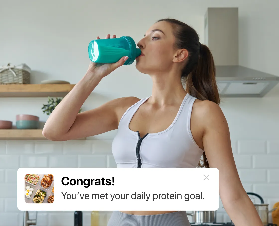 Person drinking from a shaker bottle with protein goal message overlay.