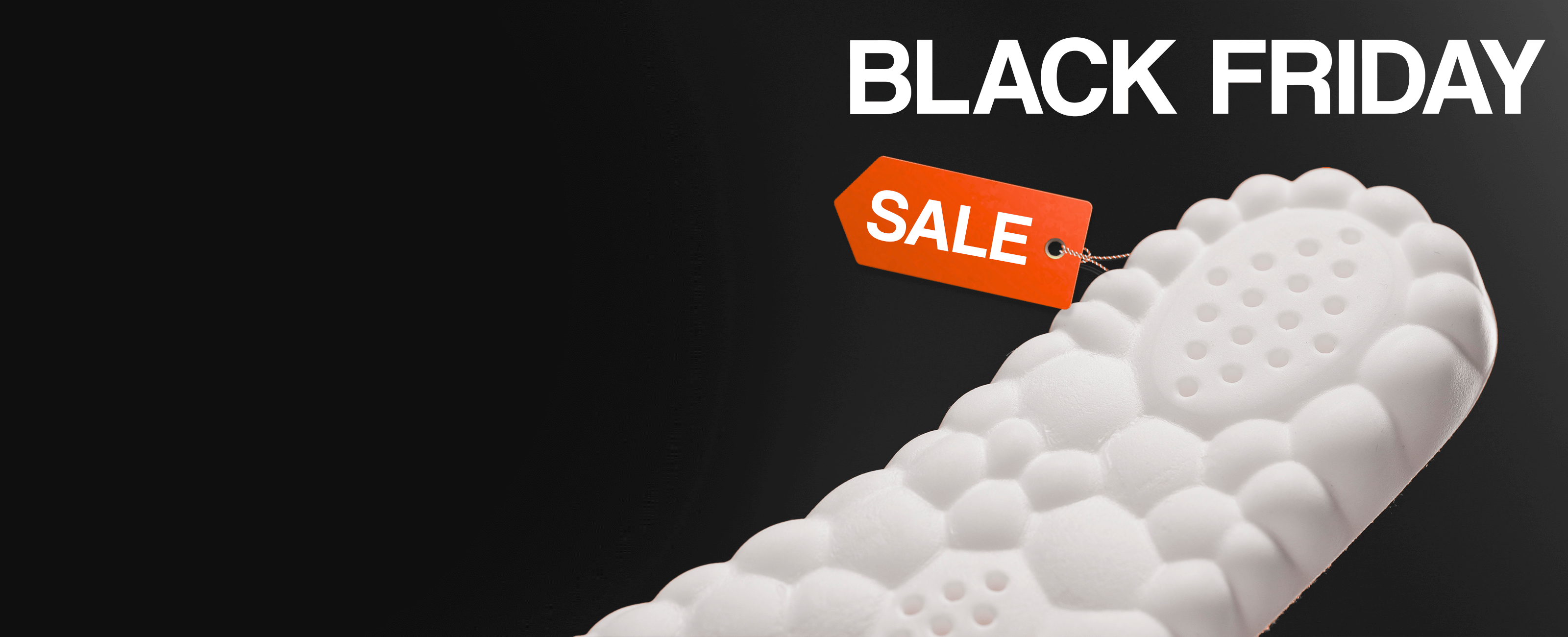 White textured shoe sole with an orange sale tag, 'Black Friday' text.