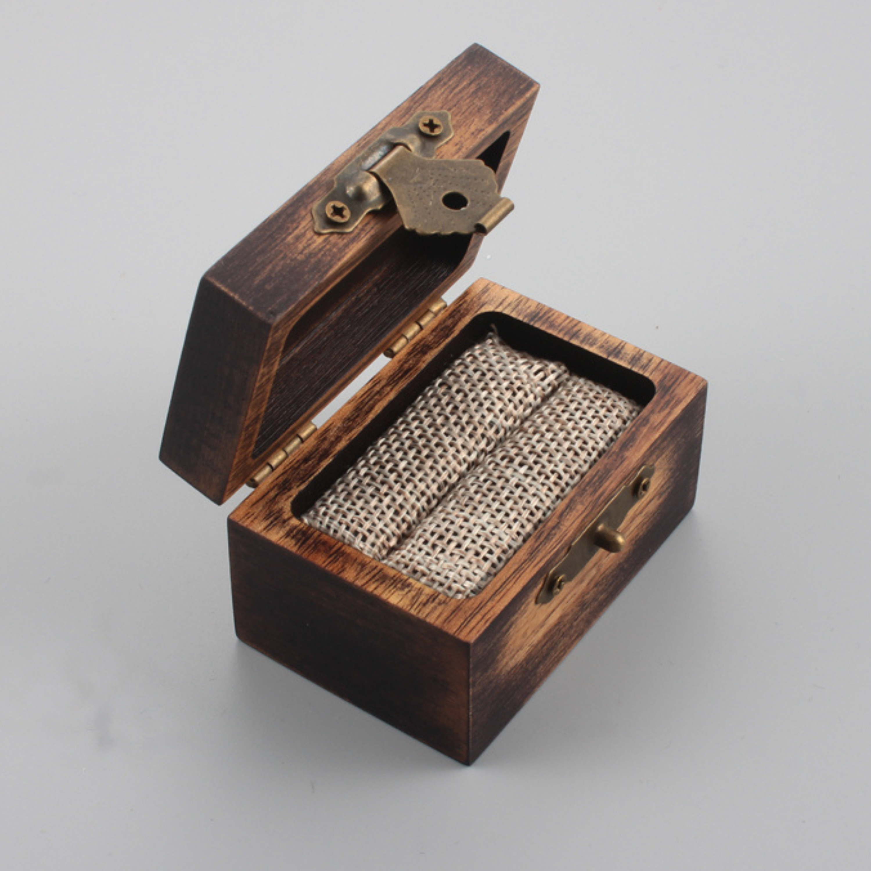 Wooden box with an open lid, revealing a burlap interior lining.