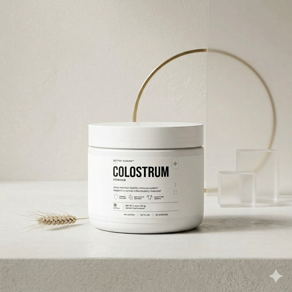 A white jar of Setter Human Colostrum Powder on a surface next to a stalk of wheat.