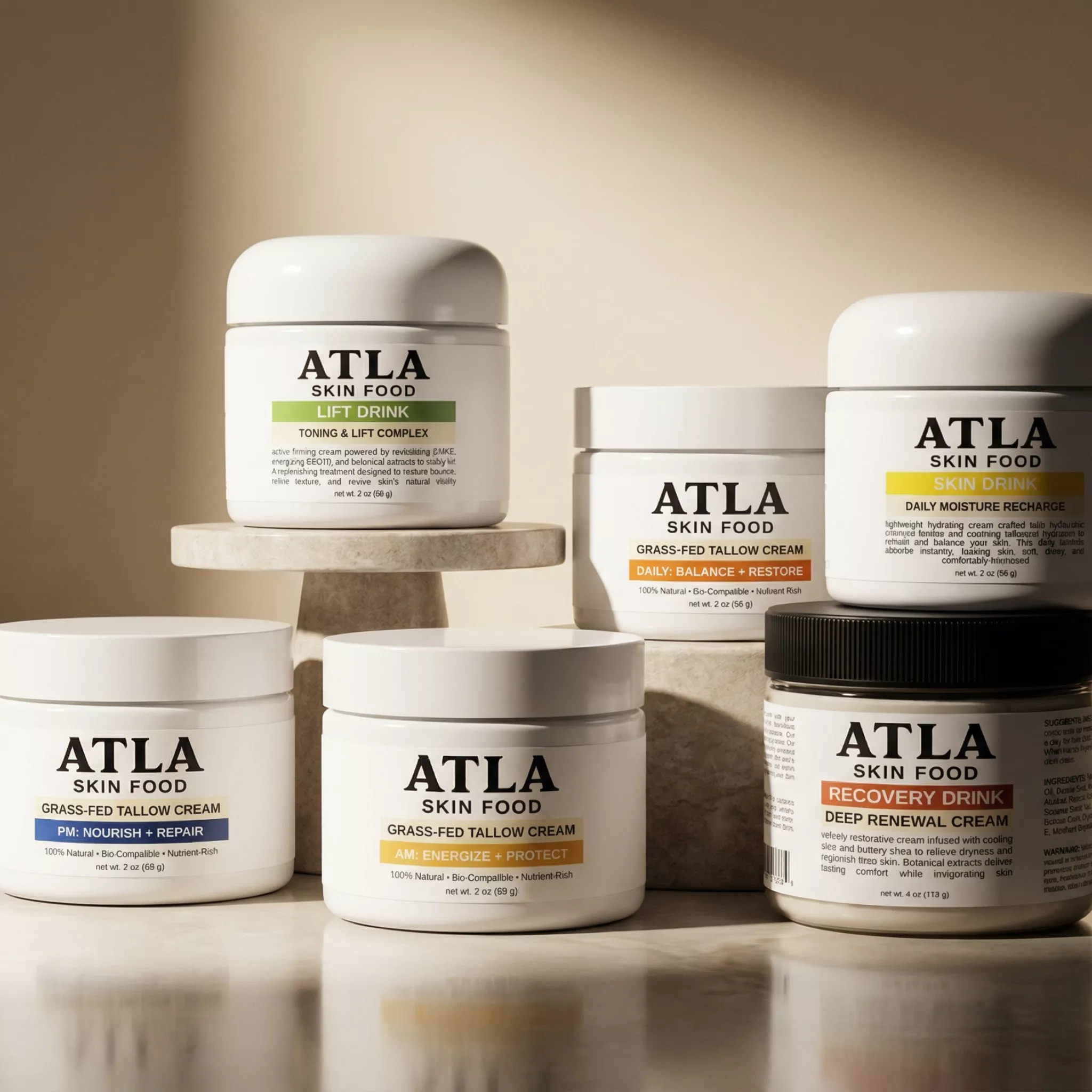 An assortment of ATLA Skin Food jars arranged on pedestals and a reflective surface.